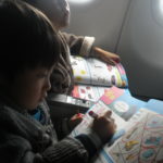 boys learning English on airplane